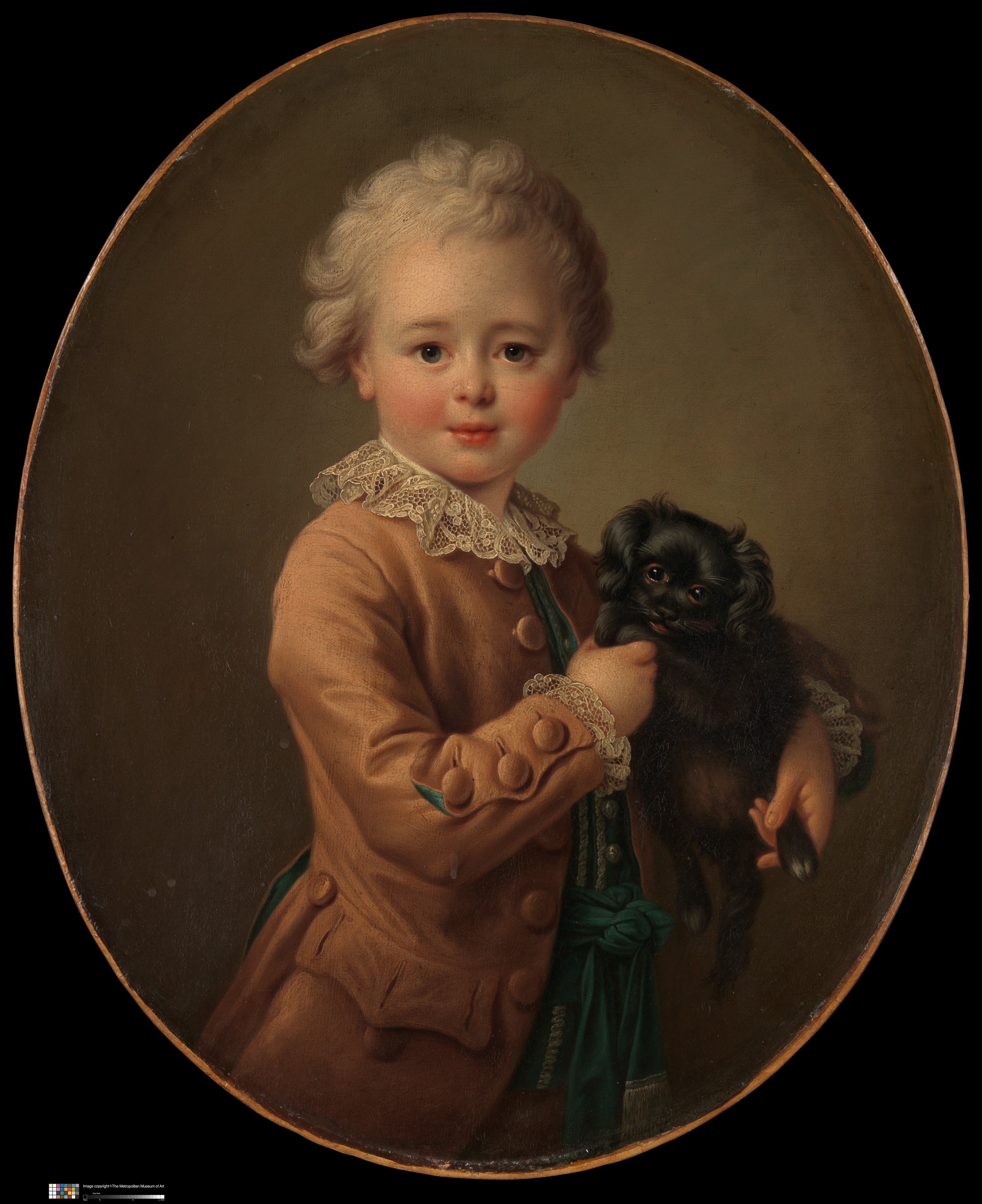 黒いスパニエル犬を連れた少年